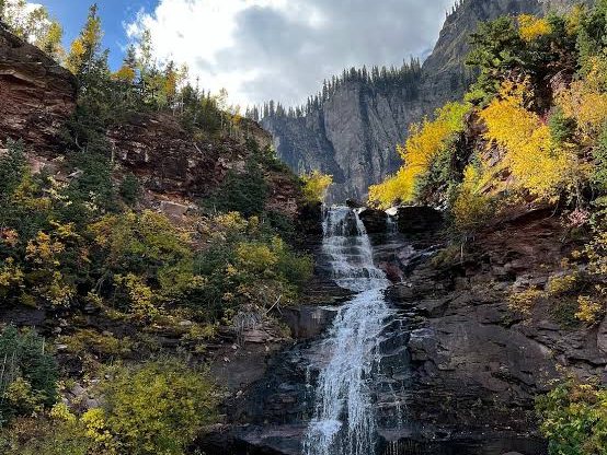 A waterfall framed by golden aspens near Telluride