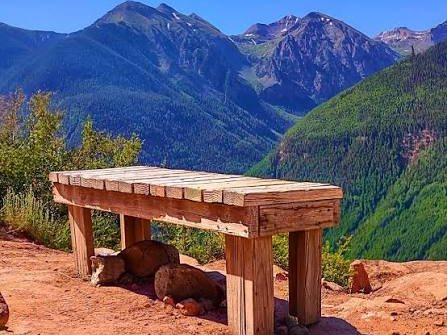 A wooden bench on the Jud Wiebe Trail overlooking the mountains