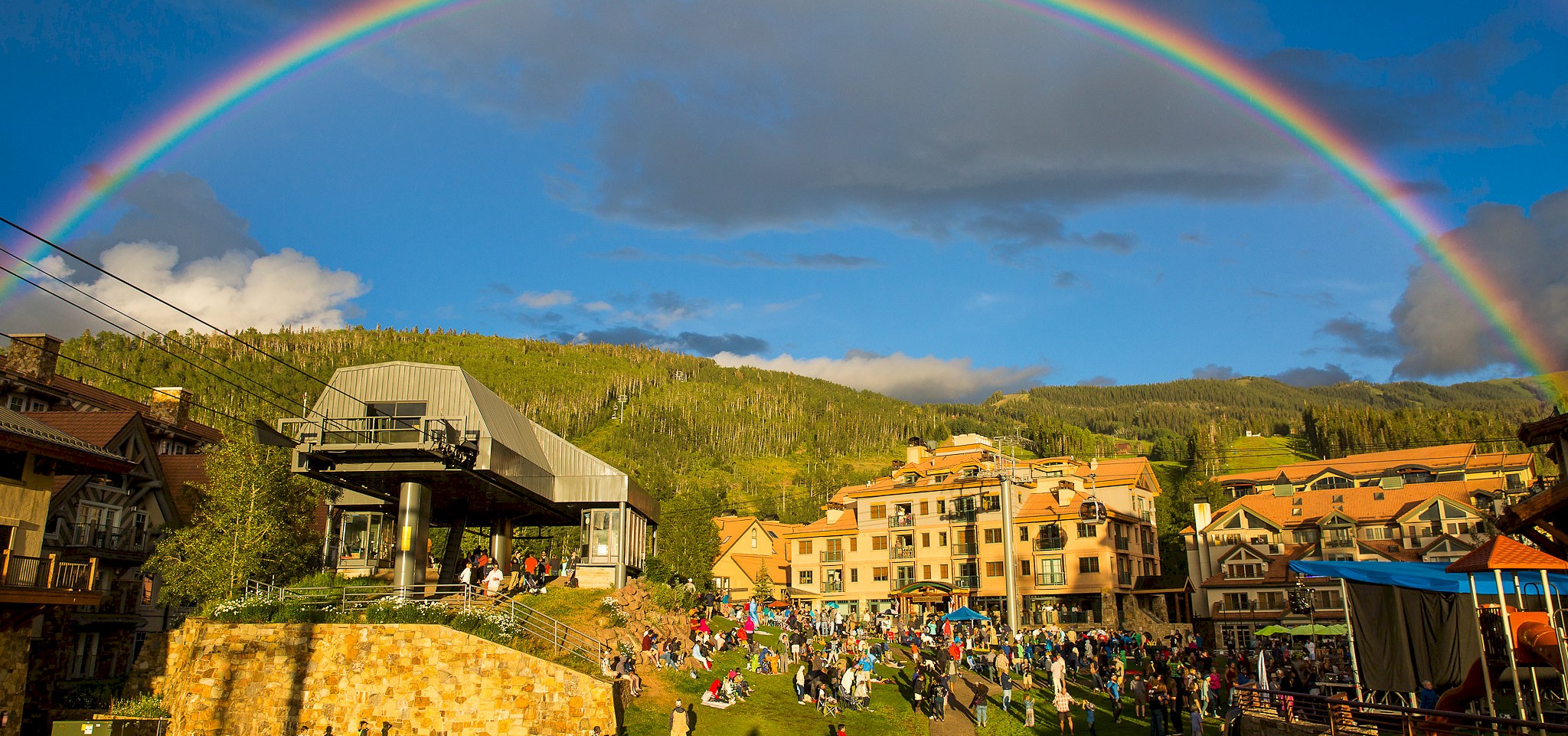 A rainbow over Mountain Village and its gondola station on a summer evening